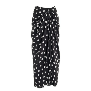 Detail of black and white polka dot sarong skirt with central gathering and soft drape