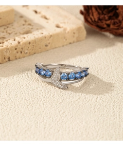 Detail of S925 silver double-layer ring with blue stones and sparkling mermaid tail