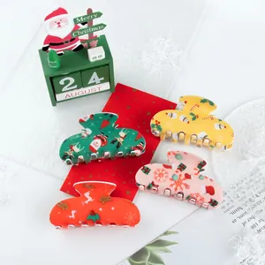Set of 4 Christmas hair claws featuring Santa and gingerbread patterns in red and green
