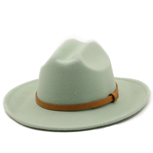 Close-up of sage green wool felt fedora with a textured brown leather decorative band