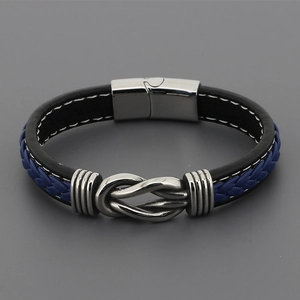Detail of multi-layer men's leather bracelet with braided rope and magnetic steel clasp