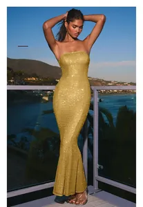 Detailed view of the sparkling gold sequins and strapless fishtail hem of this evening dress