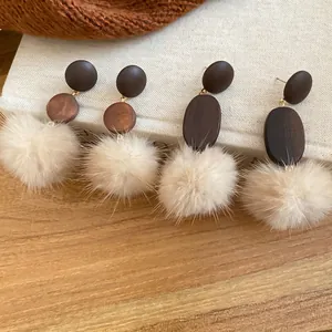 Bohemian wood and pom pom drop earrings for women in cozy autumn and winter style