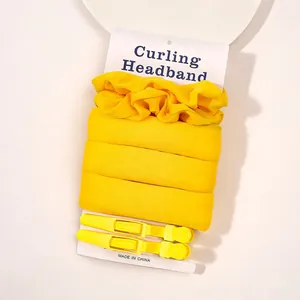 Bright yellow heatless curling headband set with two matching hair clips on card packaging