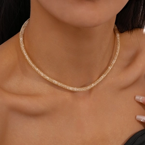 Close-up of gold zircon geometric mesh choker necklace on model showing luxury texture