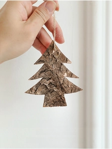 Detail of natural wood bark Christmas tree ornament with rustic texture and hanging rope