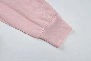 Detailed close-up of pink long sleeve cuff showing soft ribbed knit texture and material