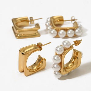 Set of gold C-shaped hoop earrings and white pearl studs in minimalist steel design
