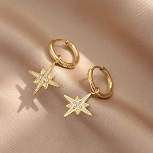 Elegant gold titanium steel star hoop earrings with crystals on a luxury satin background