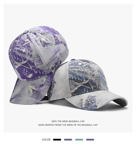 Close-up of vintage washed baseball caps in tie-dye purple and blue-grey with curved brims