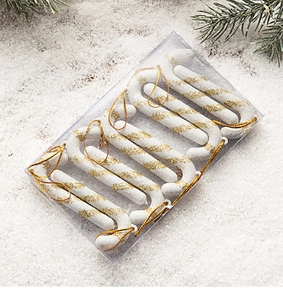 Close-up of 6-piece gold glitter candy cane ornaments for Christmas tree in box