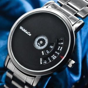Macro shot of black rotating disc watch dial with metal strap on blue fabric