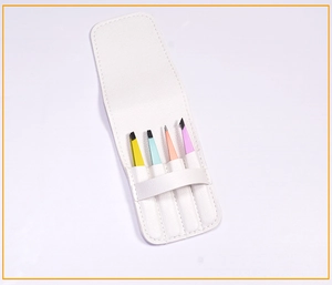Detailed view of four colorful stainless steel tweezers in a white leather storage pouch