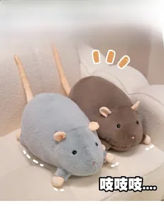 Close-up of soft plush hamster dolls in grey and brown on a cozy beige sofa
