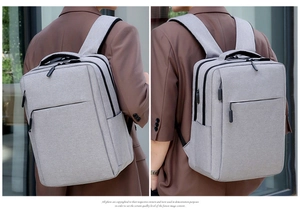 Dual view of grey business backpack with ergonomic straps and integrated USB port