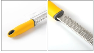 Close-up of stainless steel cheese grater with yellow handle and white protective cover