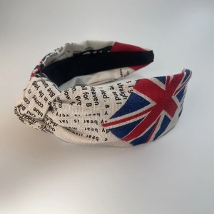 Detail view of cotton knotted headband with British flag and newspaper print patterns