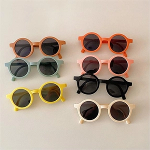 Flat lay of colorful macaron round frame sunglasses for children in various matte shades