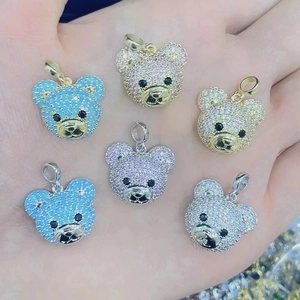 Close-up of colorful rhinestone teddy bear charms in gold and silver settings