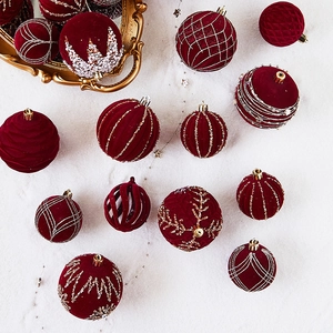 Set of burgundy flocked Christmas ornaments with gold and silver hand-painted patterns