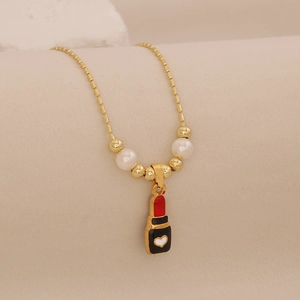 Detail of gold lipstick pendant necklace with heart accent and elegant pearl beads