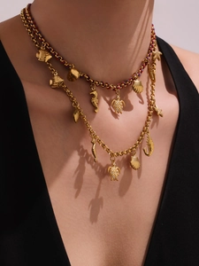 Detail of 18K gold-plated ocean-themed necklaces with turtle, seahorse, and shell charms