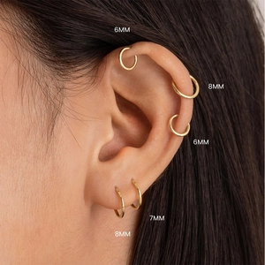 Macro detail of S925 sterling silver gold ear hoops in 6mm, 7mm, and 8mm sizes