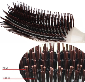 Detail view of S-shaped hair comb showing 1.5cm and 2cm bristle length measurements
