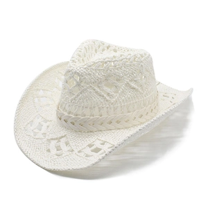 Detail of white crochet cowboy straw hat featuring hollow geometric weave patterns