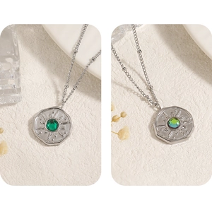Detail of sunburst octagon pendant with iridescent gemstone on silver beaded chain necklace