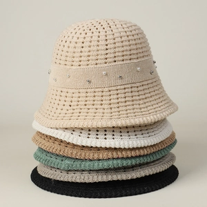 Detail of hollow knit sun hats showing bead accents and varied seasonal colors