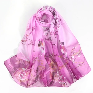 Detail of elegant magpie and floral print on lightweight chiffon silk scarf for women