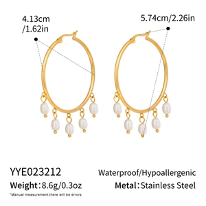 Detail of gold stainless steel hoop earrings with five white freshwater pearls