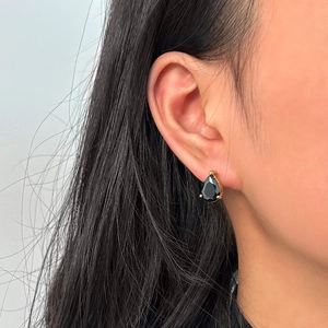 Close-up of teardrop black zircon earring with 18K gold plating on model ear