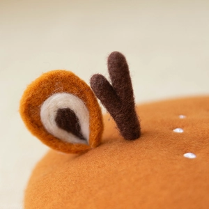 Detailed macro view of handmade wool felt deer ears and antlers on a cute beret hat