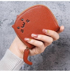 Close-up of brown cat shaped card holder with litchi grain texture and cute cat embroidery