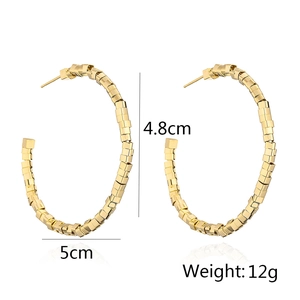 Detail of 5cm gold-plated geometric cube hoop earrings with 12g weight and C-shape design