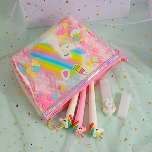 Detail of pink unicorn cosmetic pouch with rainbow sequins and glitter stationery items