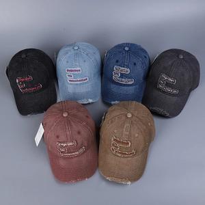 Set of distressed denim baseball caps featuring embroidered text in multiple colors