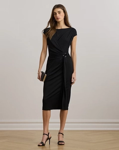 Detail of elegant black midi dress featuring metal ring accent and side waist gathering