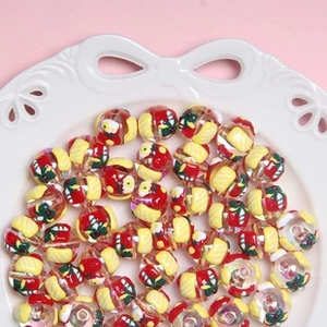 Macro view of colorful printed acrylic beads in a tray for DIY jewelry making