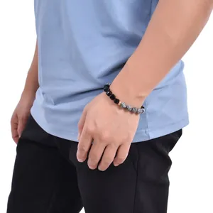 Detail of 10mm faceted black obsidian and turquoise beads on a men's woven bracelet