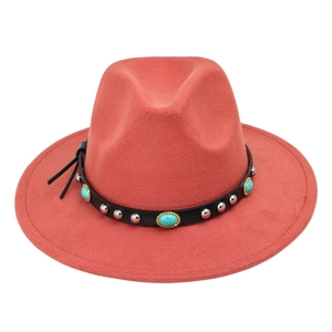 Detail of coral red felt hat featuring turquoise stones and silver studs on black band