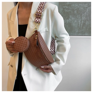 Close-up of brown woven leather waist bag with mini round pouch and geometric wide strap