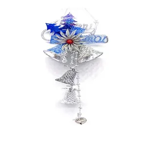 Close-up of blue and silver Christmas tree bell ornaments with Merry Christmas sign
