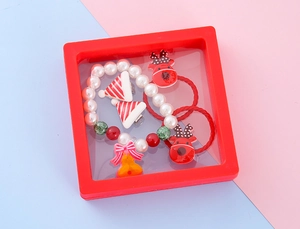 Close-up of Christmas jewelry gift set with reindeer hair ties and pearl bracelets