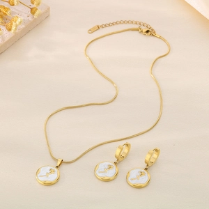 Golden necklace and earrings set featuring white circular pendants with rose pattern