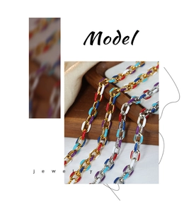 Macro detail of multi-color enamel paperclip chain necklace in gold and silver finish