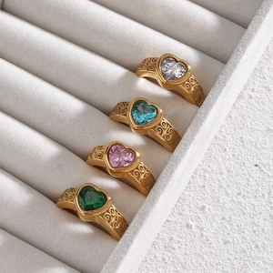 Four vintage golden rings with colorful heart zircon stones and engraved patterns