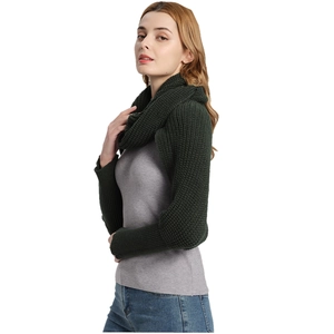 Knitted dark green scarf with sleeves worn by model on a white background